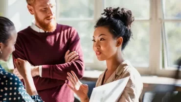 Group of professionals having a discussion in a bright office.