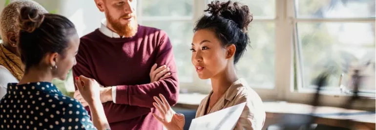Group of professionals having a discussion in a bright office.