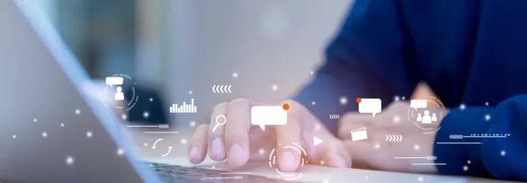 Person using a laptop with digital communication icons overlay.