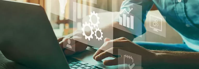 Person typing on laptop with digital icons like graphs and gears overlayed.