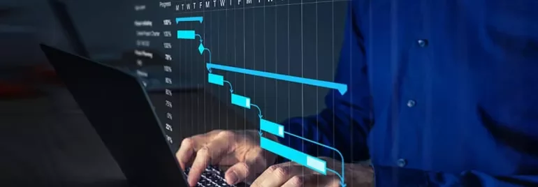 Person using a laptop with a visible project timeline chart on screen.