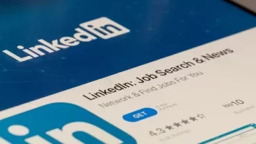Tablet displaying LinkedIn app download page on a screen.