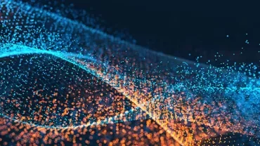 Abstract image of blue and orange particles forming wave-like patterns.