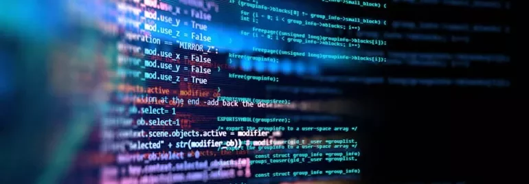 Close-up of colorful computer code lines on a black screen.